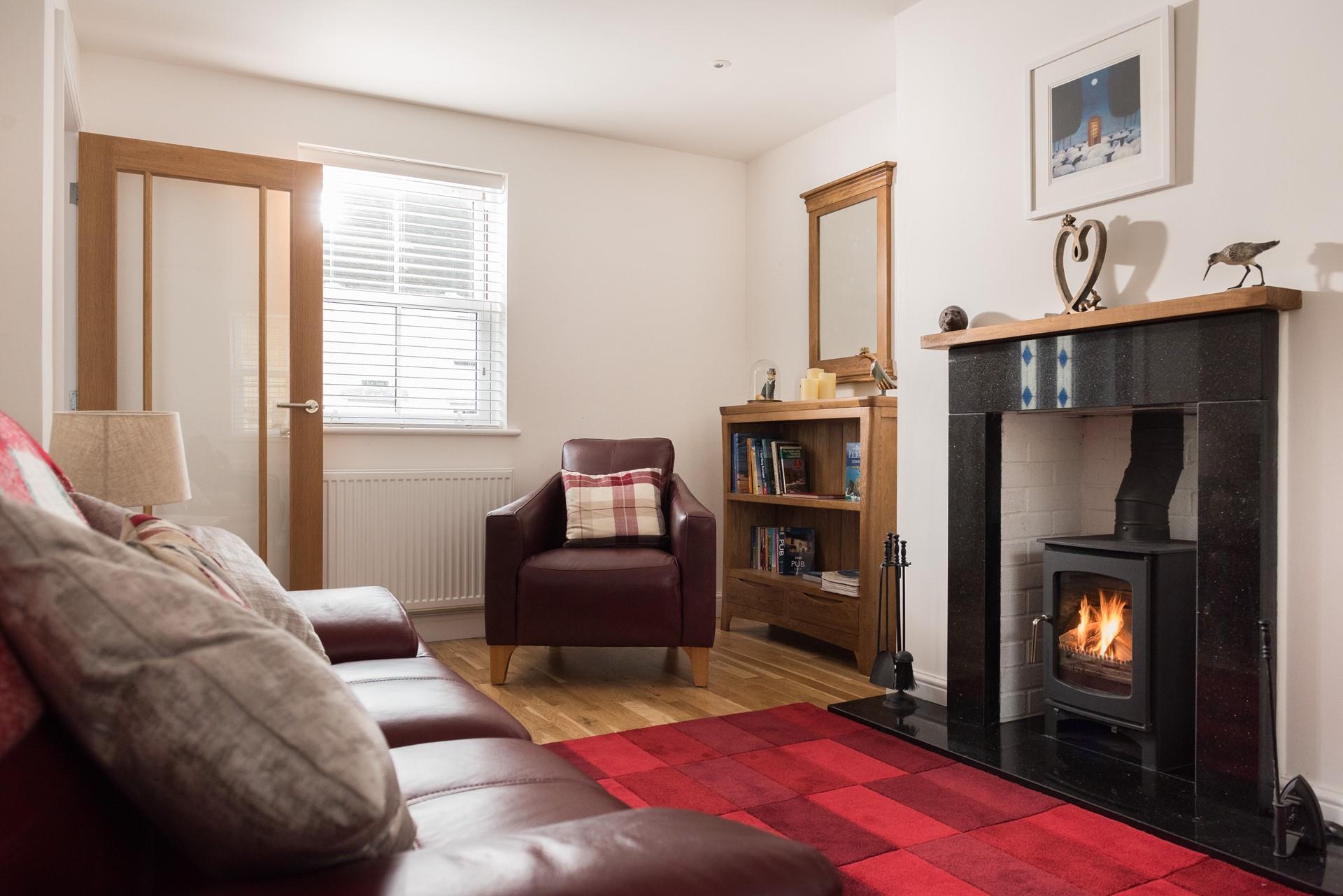 The cosy lounge with a welcoming woodburner is fabulous for relaxing after a busy day.