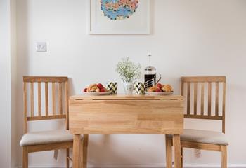 A dining table and additional breakfast bar ensure that there is room for everyone to gather for family meals.