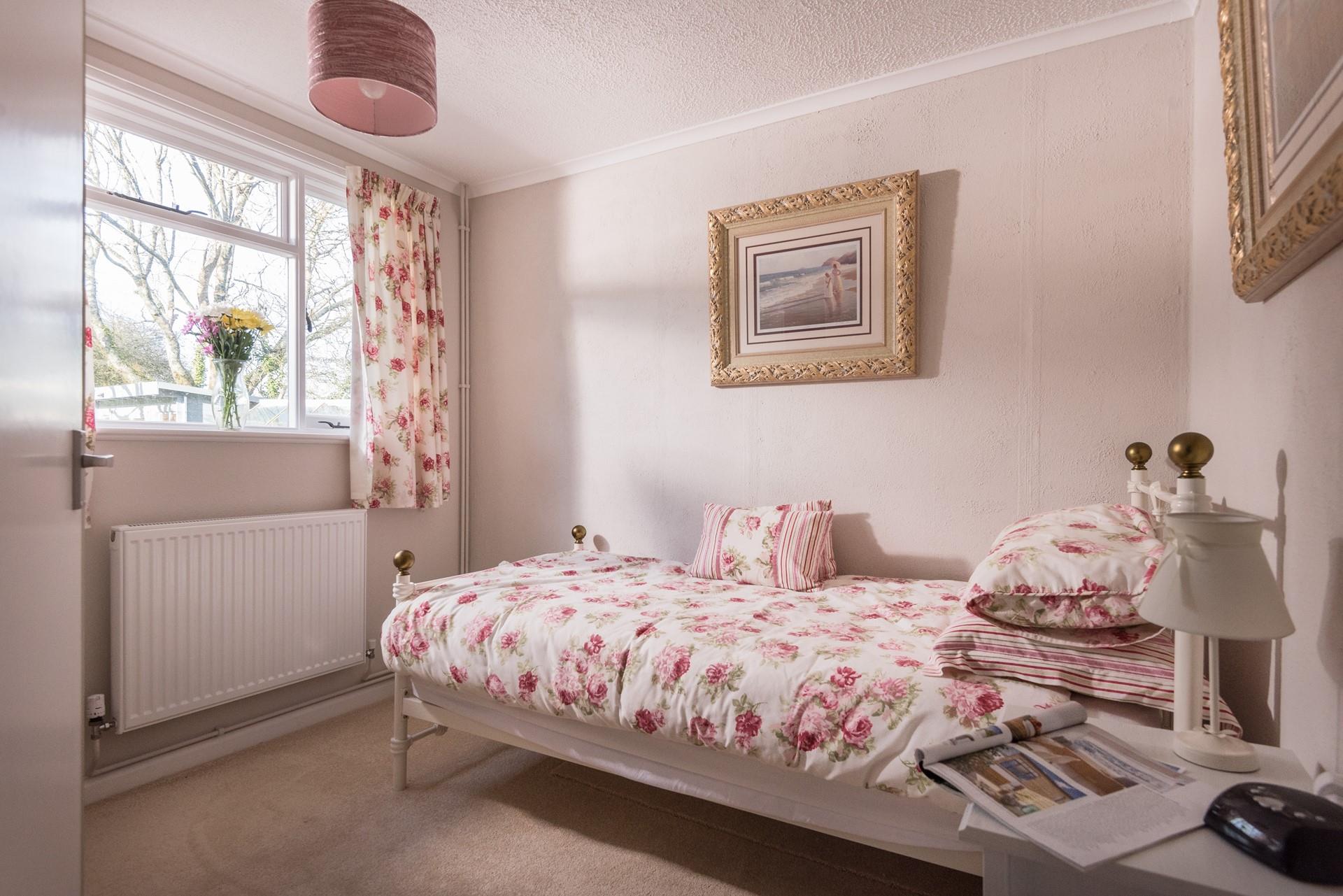 Pretty floral decor and luxurious gold frames give this room a touch of elegance. 