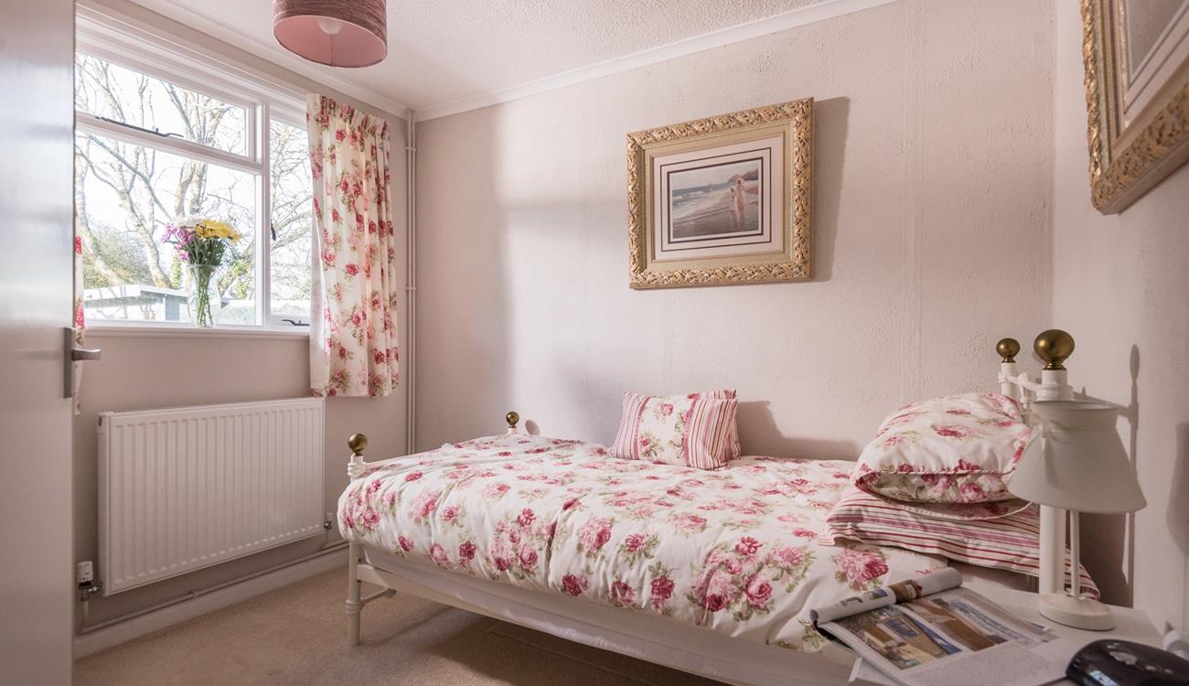 Pretty floral decor and luxurious gold frames give this room a touch of elegance. 