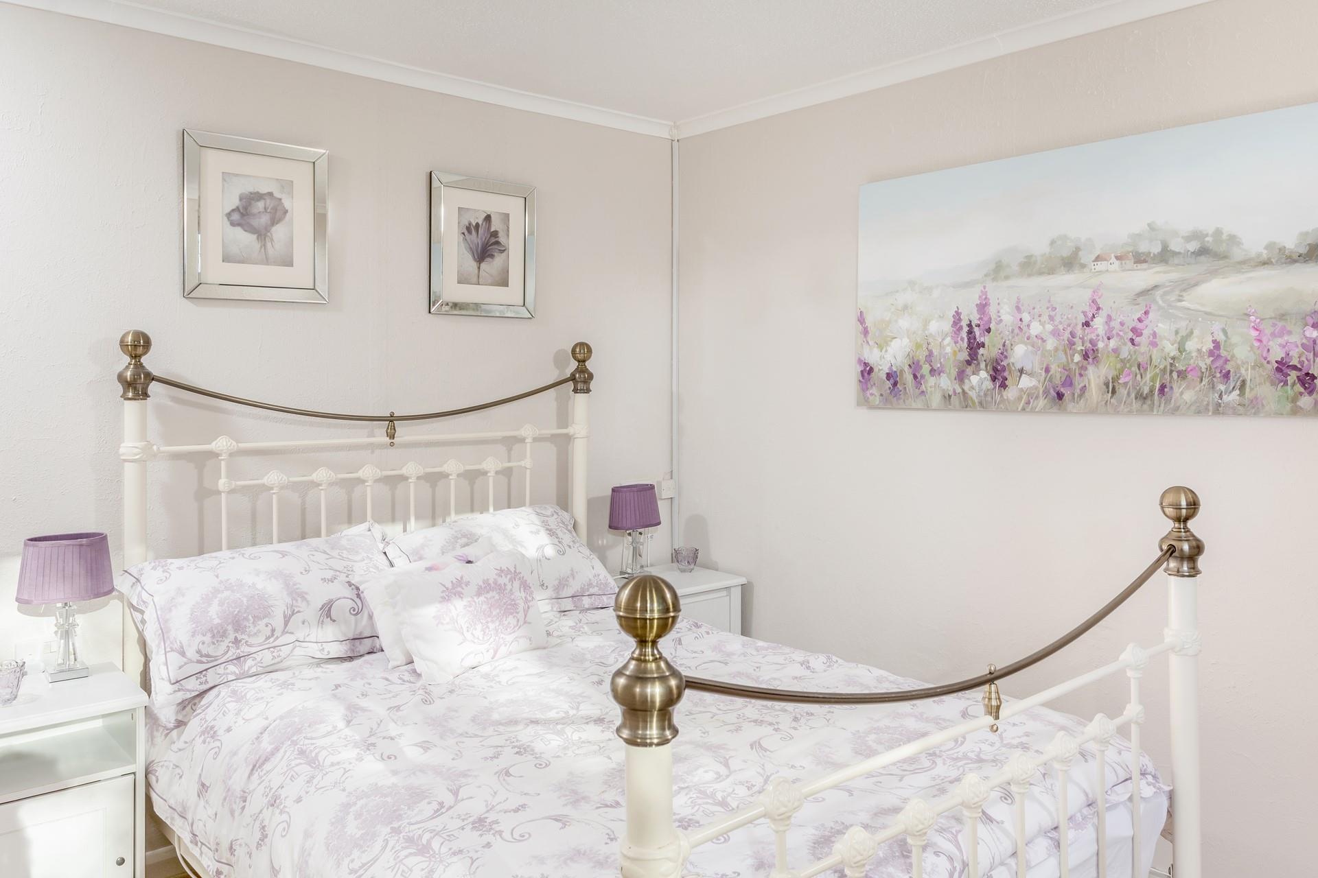 Soft shades of purple create a soothing atmosphere, perfect for unwinding after a full day of exploring Cornwall.
