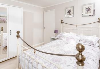 Pretty purples and prints make this bedroom another cosy space for enjoying a lazy lie in. 