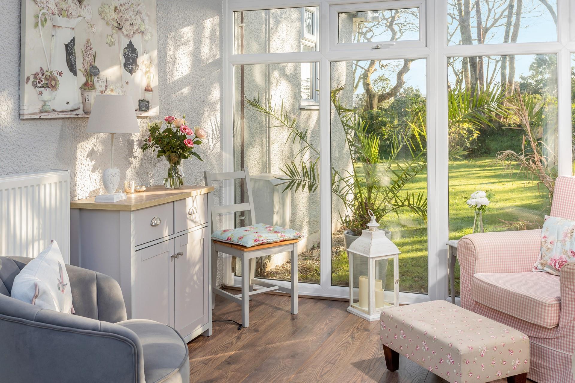 The conservatory has pink and grey pastel hues creating a calming space to relax.
