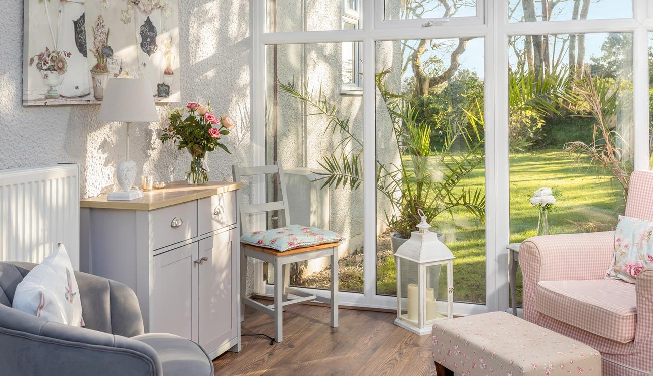 The conservatory has pink and grey pastel hues creating a calming space to relax.