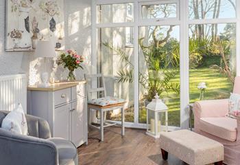 The conservatory has pink and grey pastel hues creating a calming space to relax.