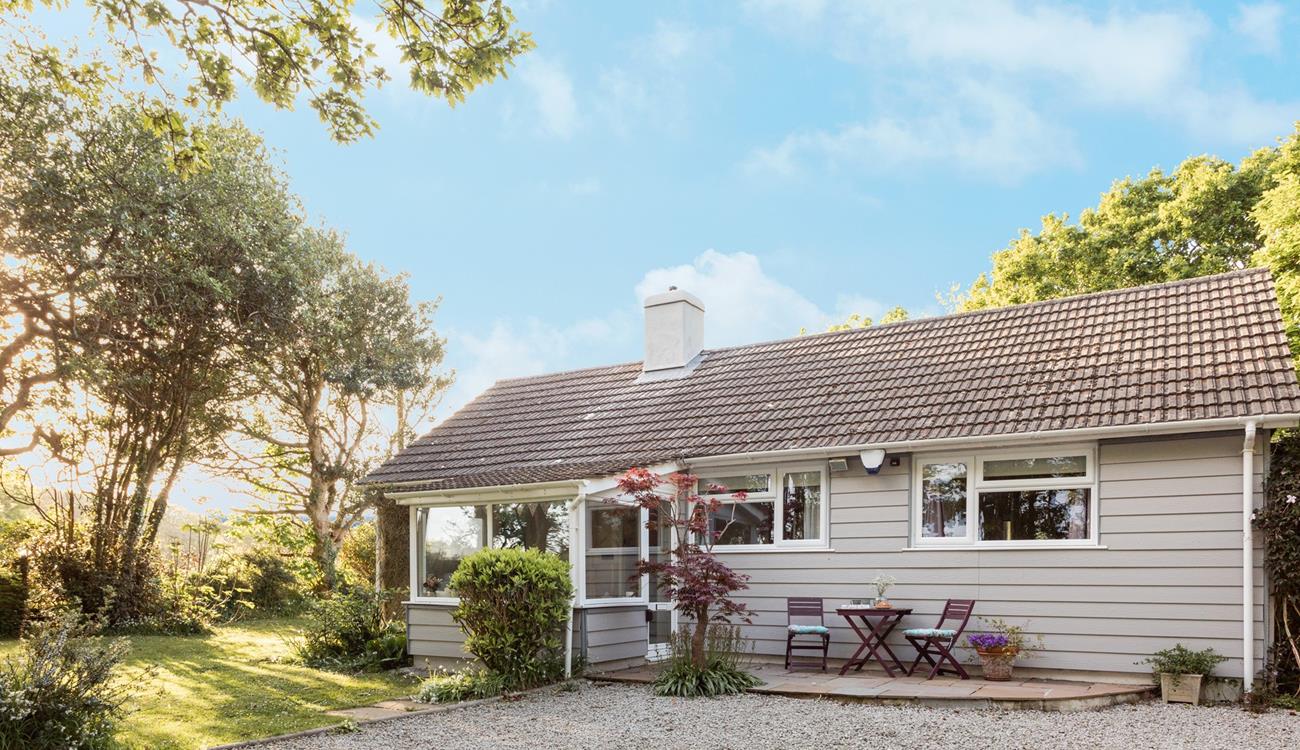 The gravel drive with a gate has parking for two cars, offering both privacy and security.