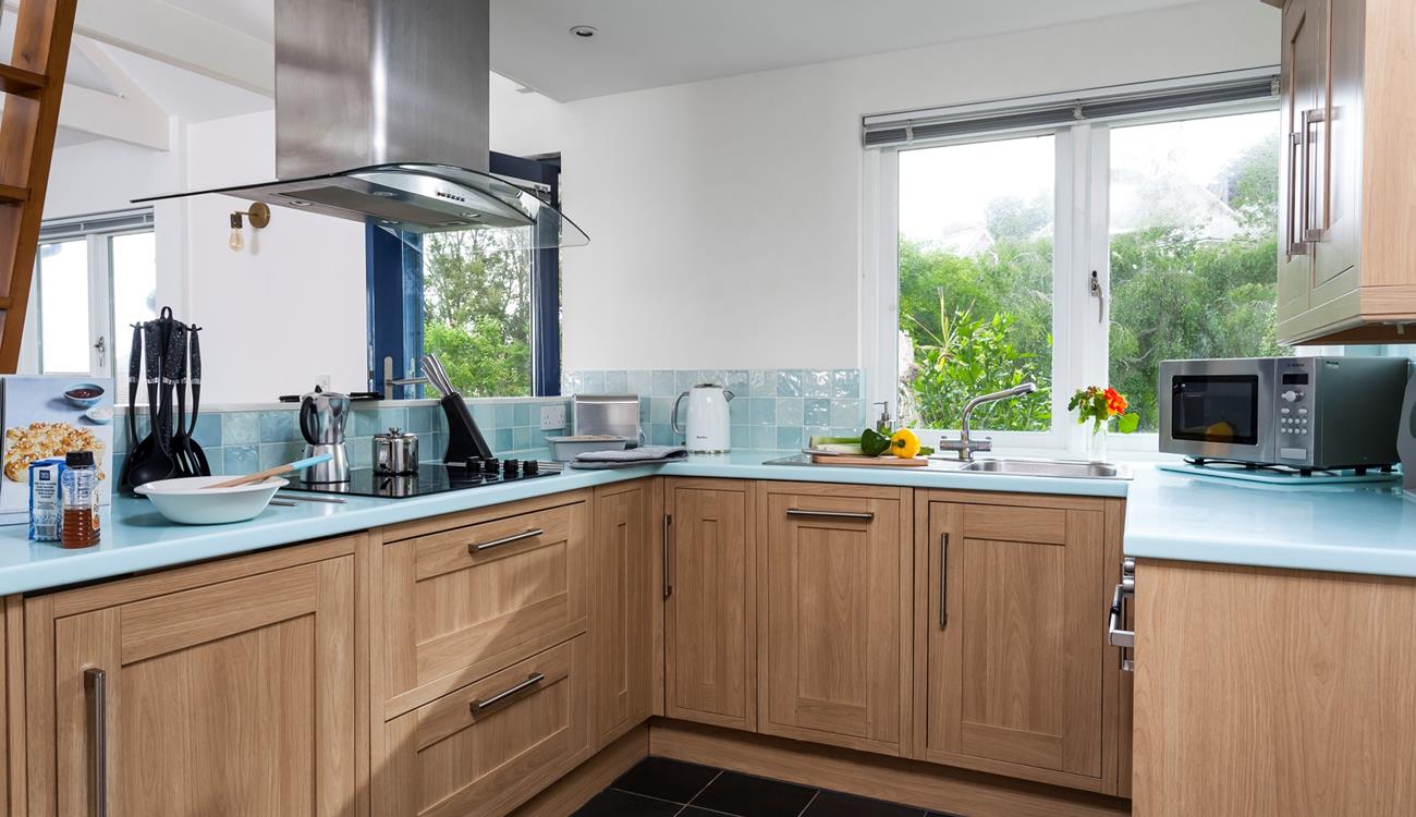 Cook up some culinary delights with a glorious garden view in the open living area. 