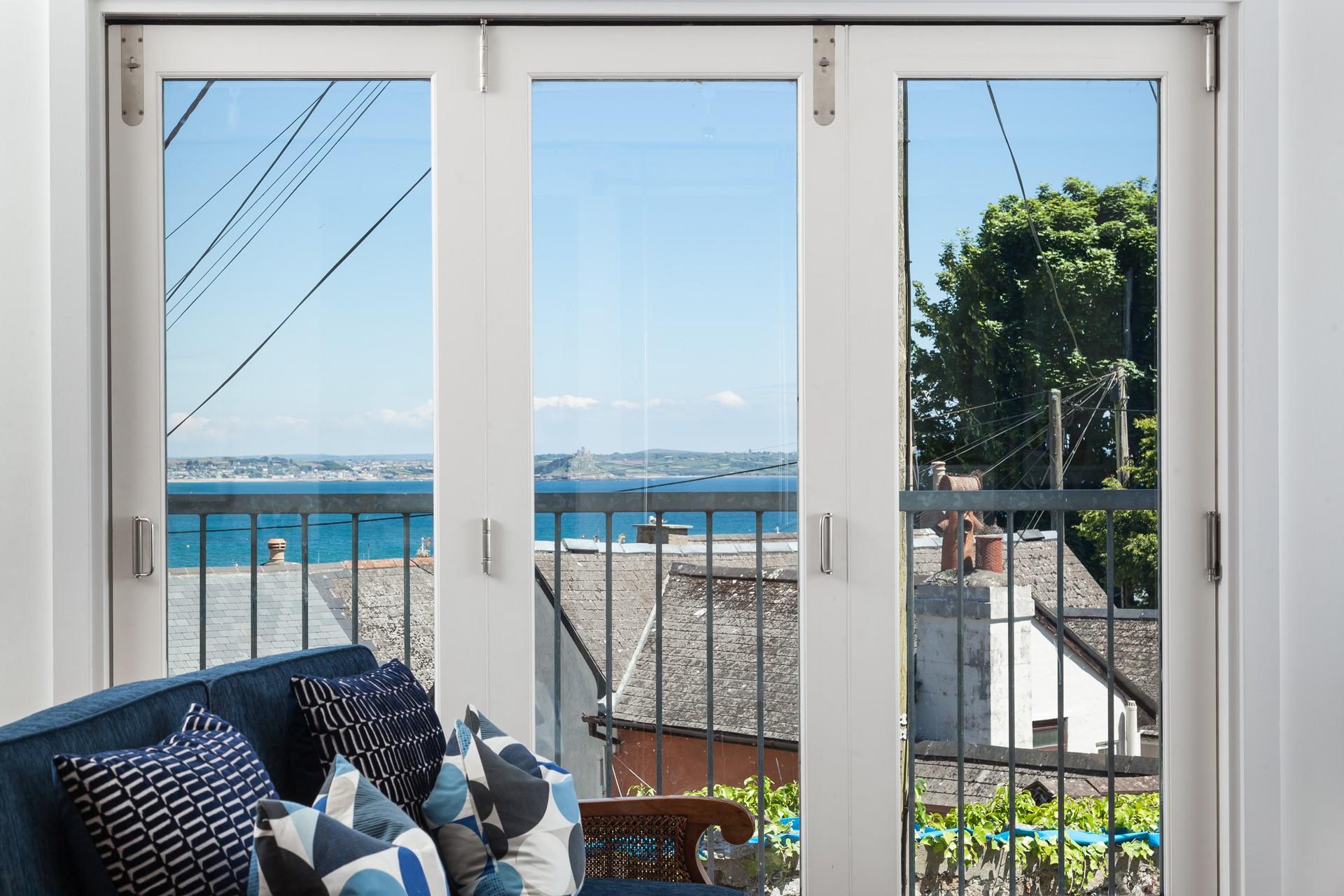 Sit in the window and gaze out towards St Michael's Mount with a cold drink in hand.