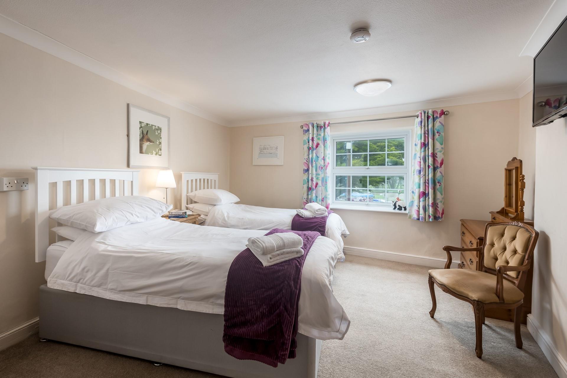 The twin bedroom allows for flexible sleeping arrangements.