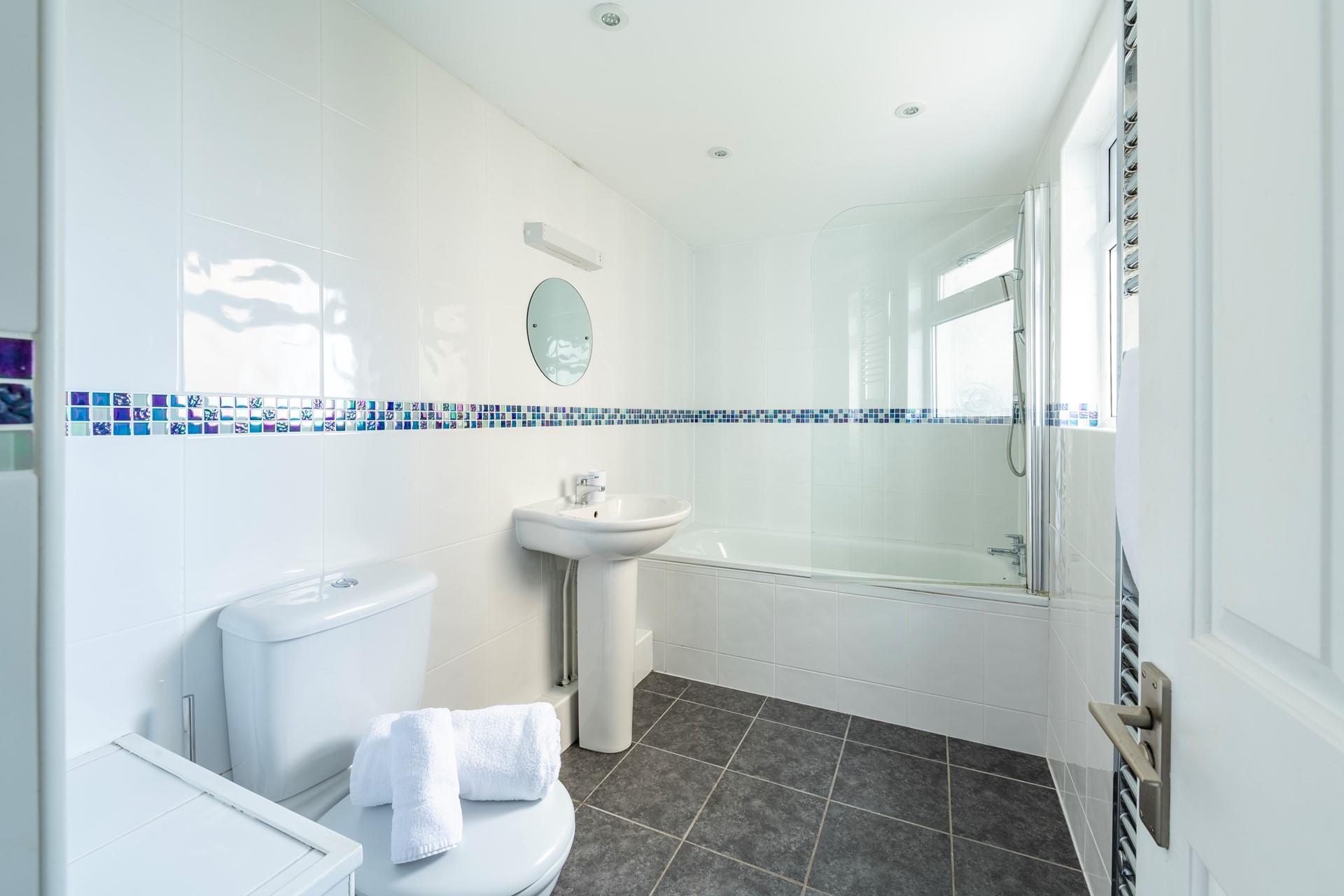 The family bathroom is perfect for a morning shower or relaxing bath.