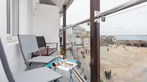 Watch the comings and goings of the harbour from the balcony.