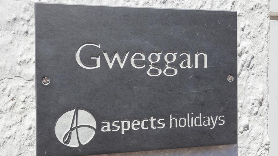 A traditional slate sign helps make the property easy to find.