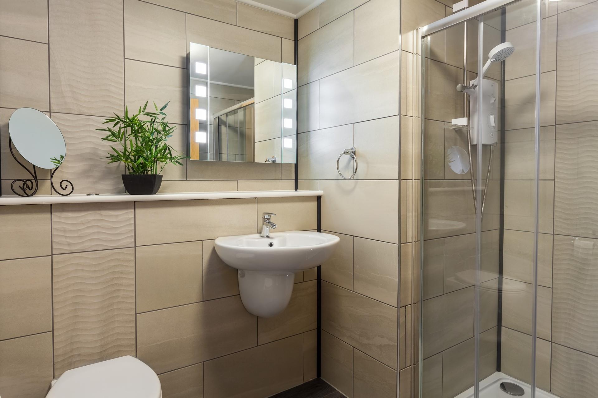 The en suite is stylishly decorated, creating a stunning space for a morning shower or to freshen up before a night out.