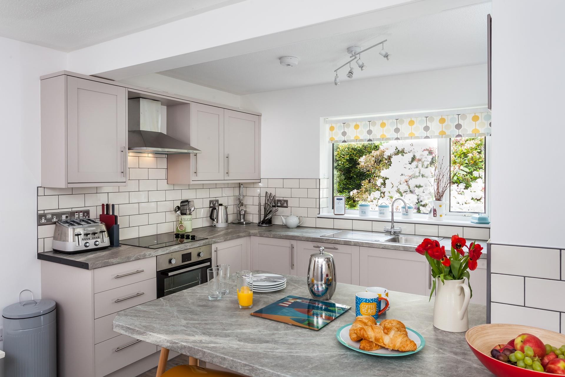 The kitchen is well-equipped and fitted with modern appliances, fantastic for whipping up home-cooked meals!