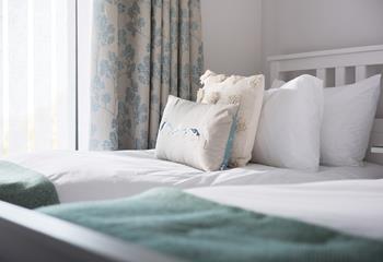 Bedroom 2 has muted tones making it a calming space, perfect for unwinding and drifting off to sleep.