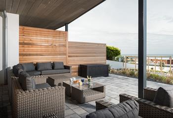 Comfortable lounge furniture is perfect for relaxing after the beach and watching the sun set over Fistral beach.