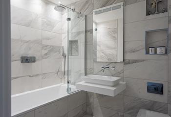 The beautiful family bathroom is just the spot for a relaxing soak after a long day at the beach. 