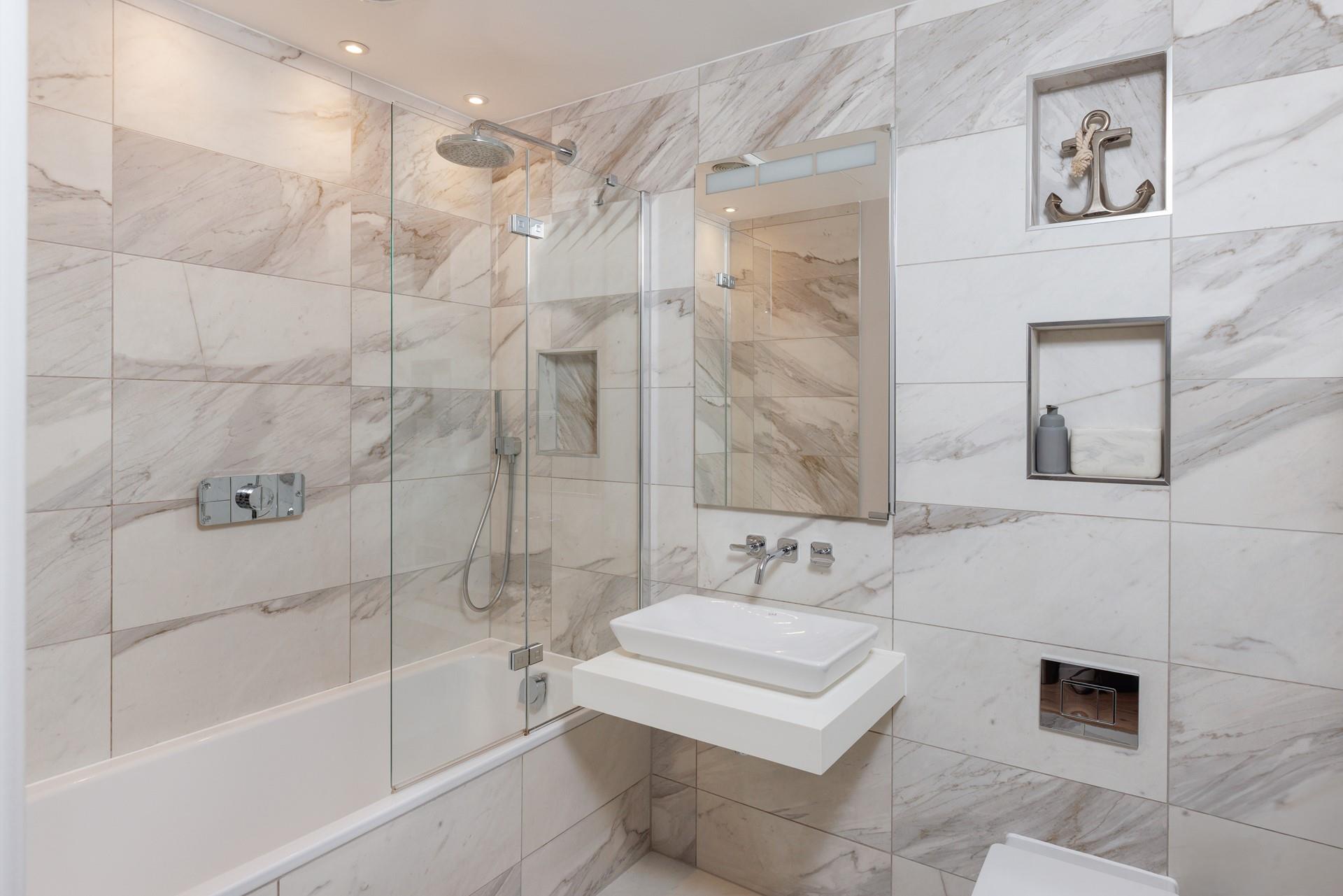 The beautiful family bathroom is just the spot for a relaxing soak after a long day at the beach. 