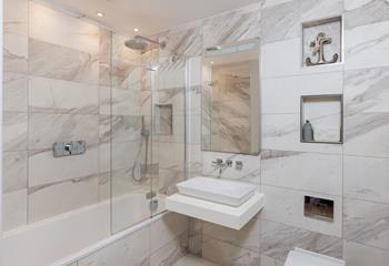 The beautiful family bathroom is just the spot for a relaxing soak after a long day at the beach. 