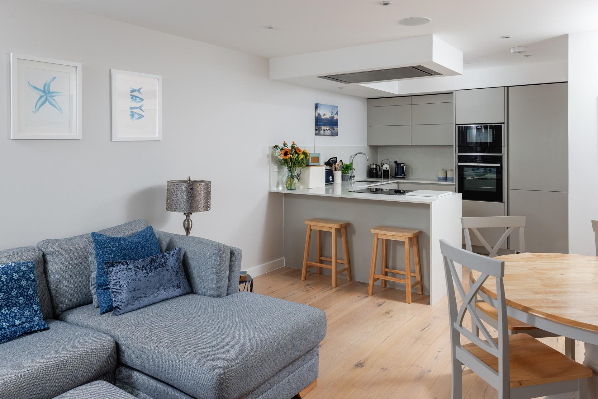 Coastal inspired artwork fills the living space.