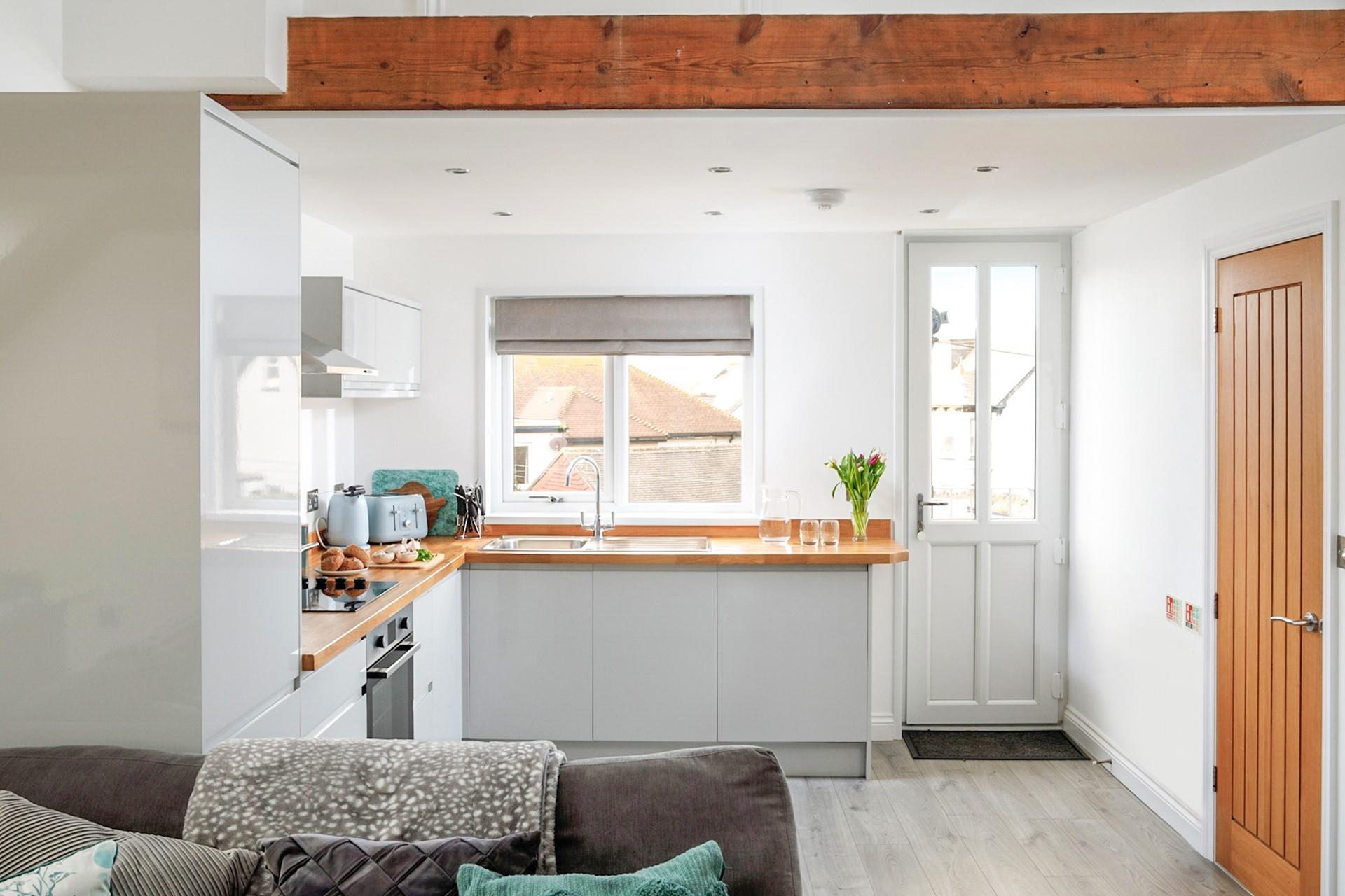 The kitchen leads out to the sun trap terrace, the perfect space for enjoying an afternoon drink or two.