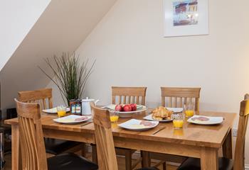 Enjoy breakfast on this solid wood table complete with matching leather cushioned chairs.