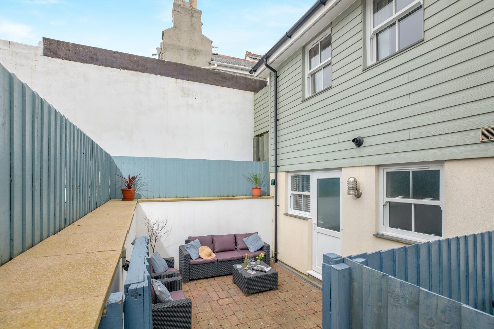 An enclosed patio area at the rear of the property is the perfect space for some al fresco dining. 