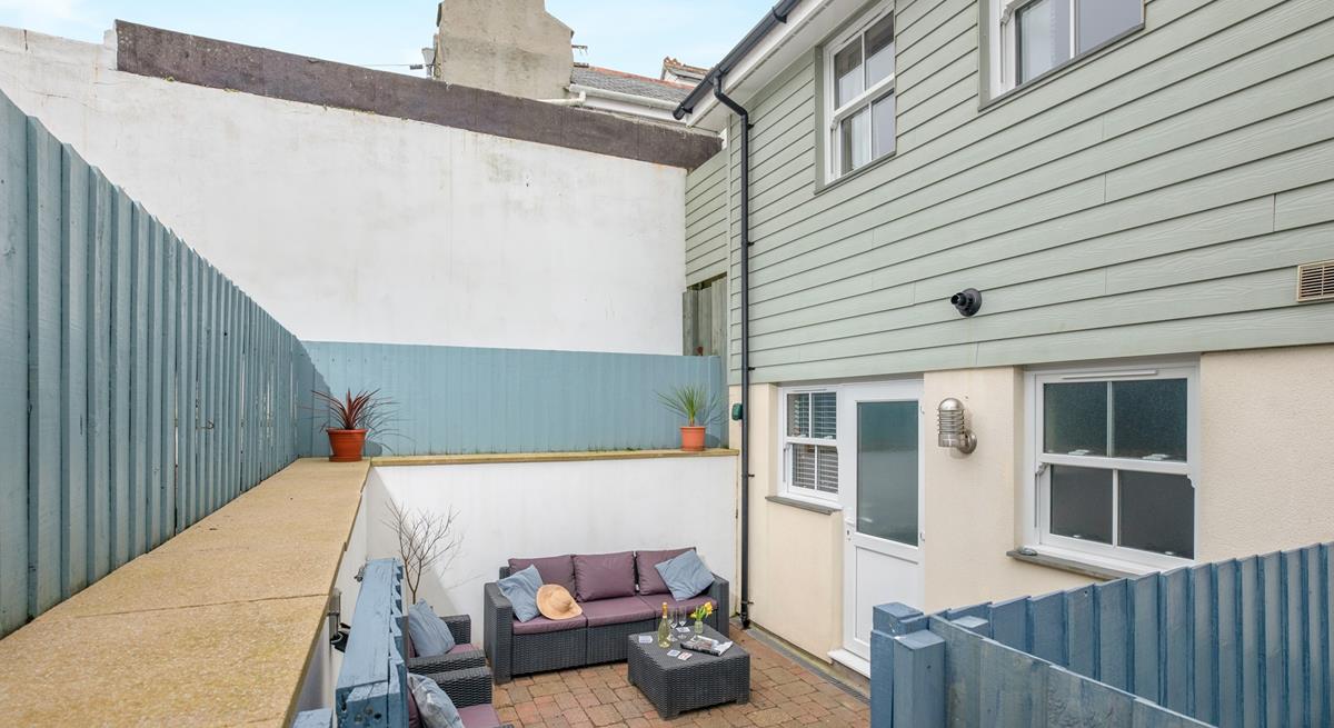 An enclosed patio area at the rear of the property is the perfect space for some al fresco dining. 