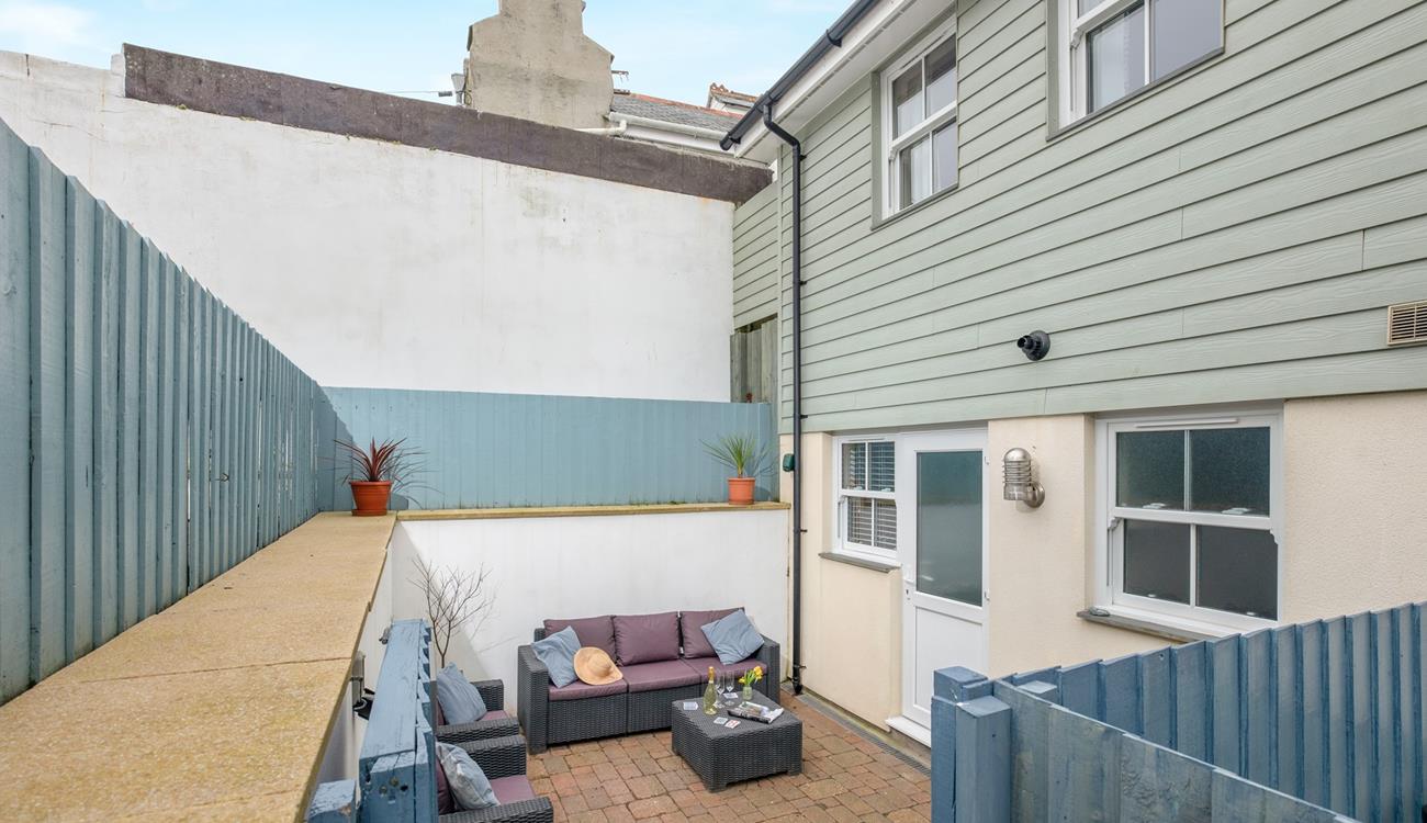 An enclosed patio area at the rear of the property is the perfect space for some al fresco dining. 