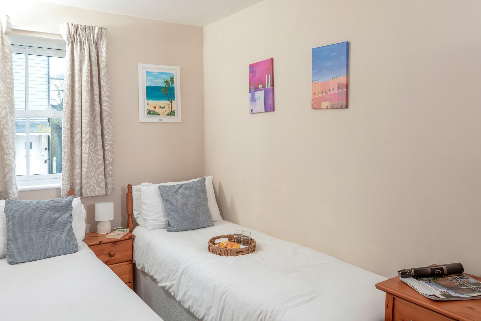 Bedroom two benefits from twin beds, perfect for young adults or teenagers wanting their own space.