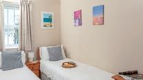 Bedroom two benefits from twin beds, perfect for young adults or teenagers wanting their own space.