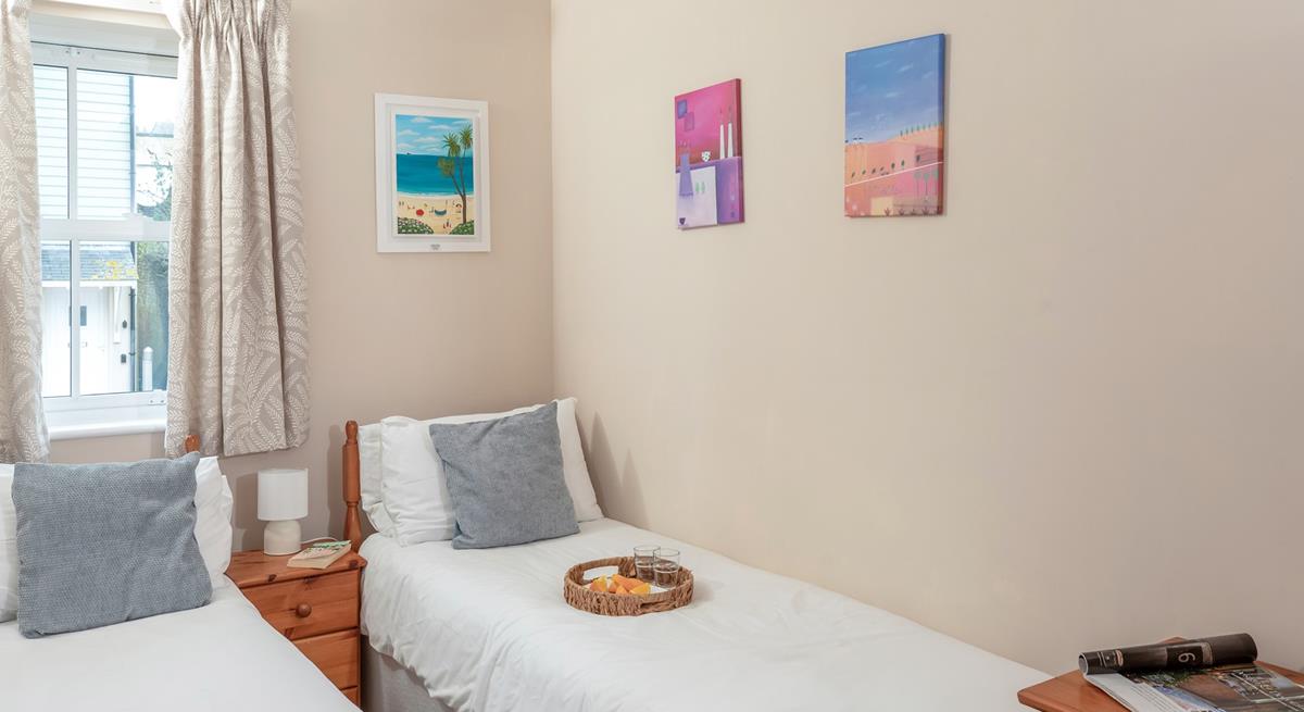 Bedroom two benefits from twin beds, perfect for young adults or teenagers wanting their own space.