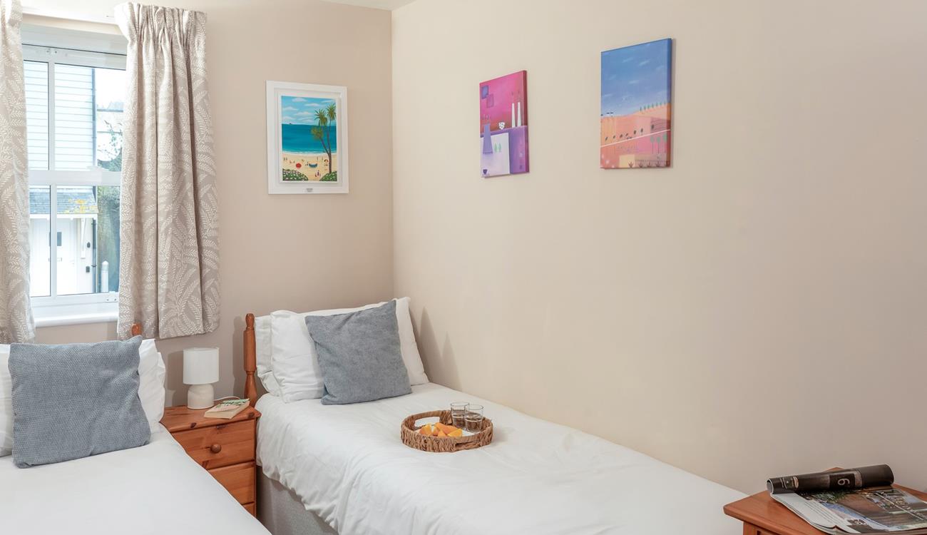 Bedroom two benefits from twin beds, perfect for young adults or teenagers wanting their own space.