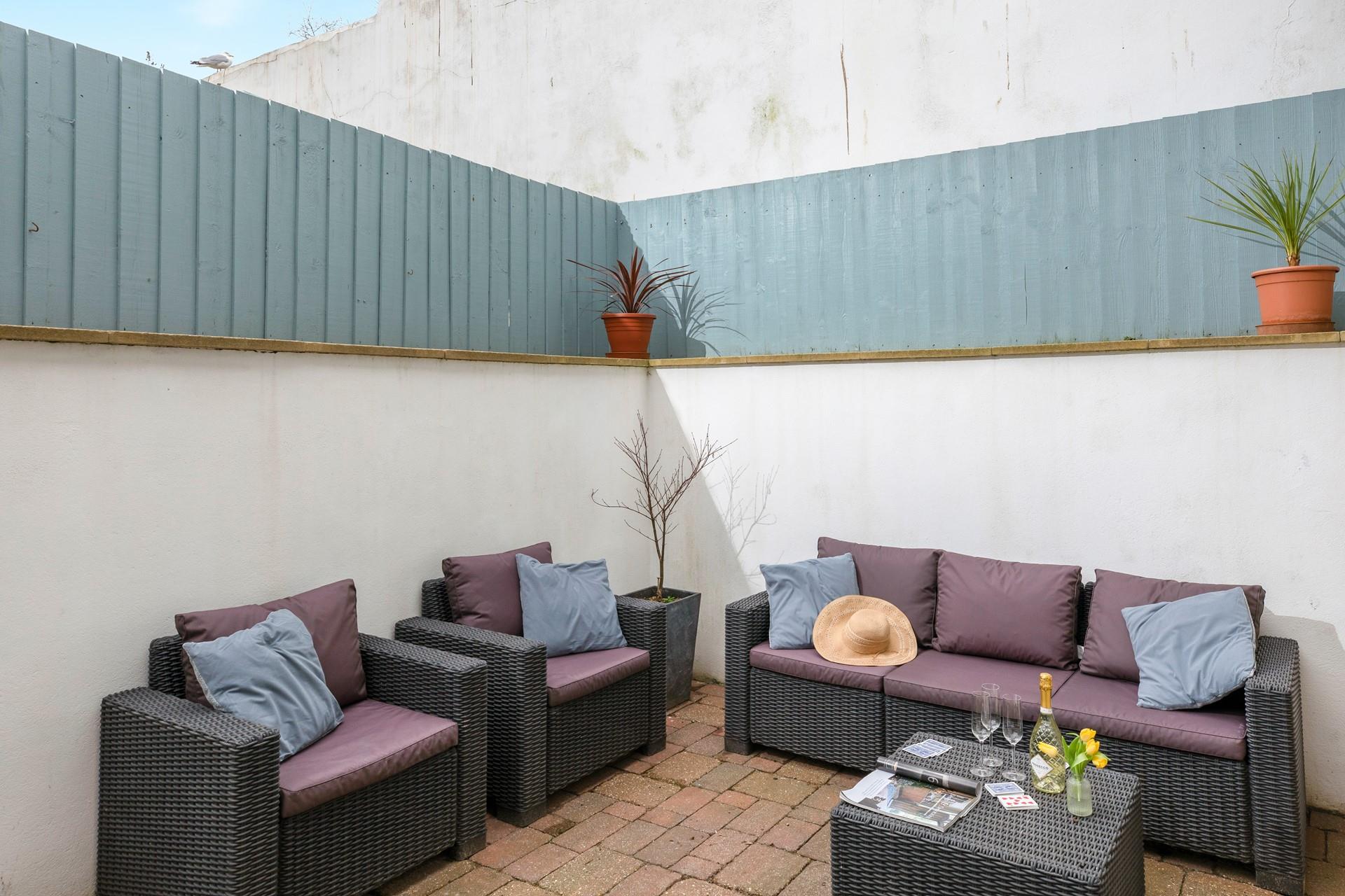 Fully enclosed, the patio is a great spot for unwinding and perfect for dogs!