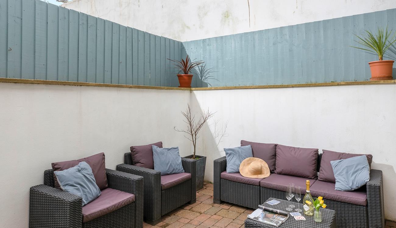 Fully enclosed, the patio is a great spot for unwinding and perfect for dogs!