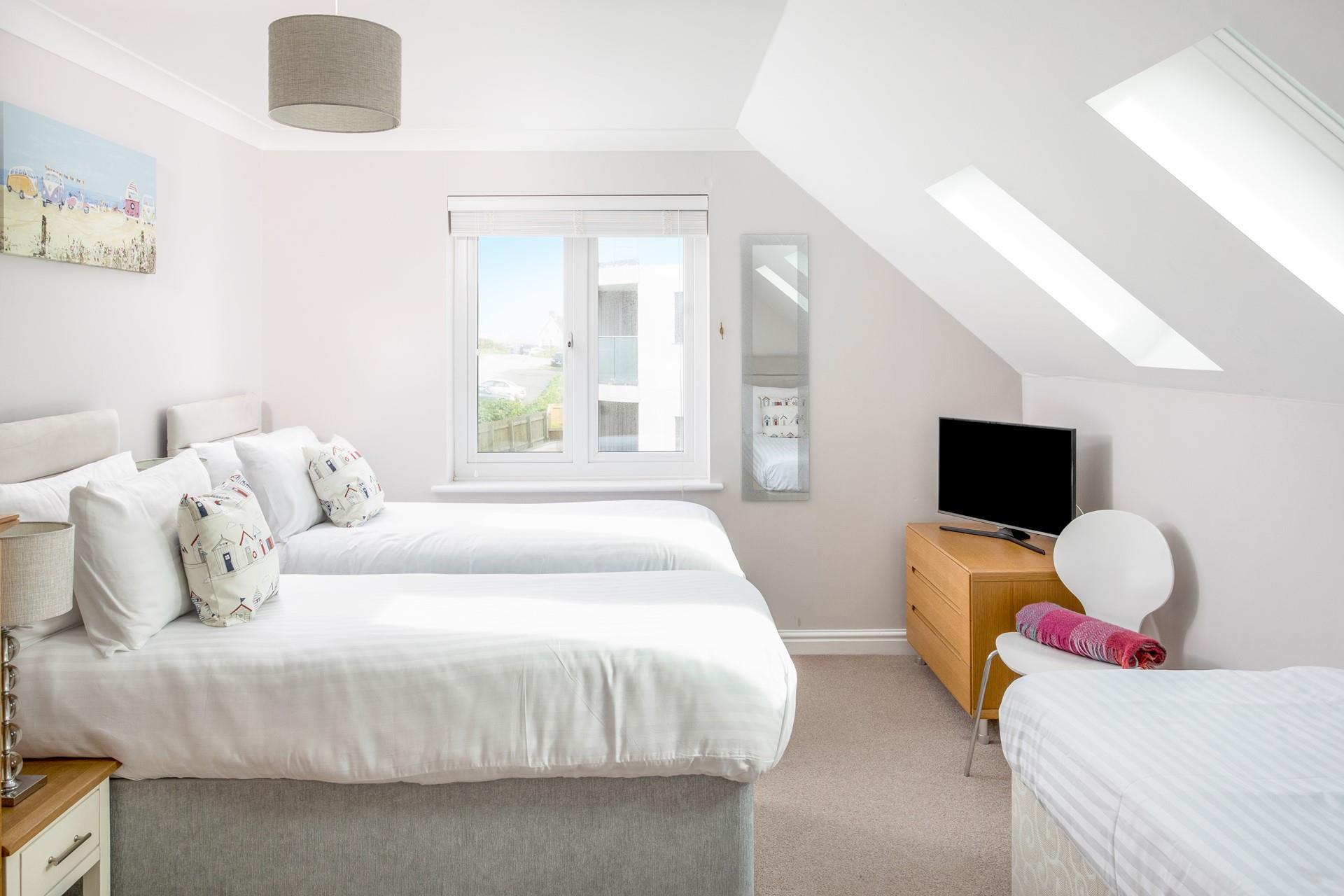 Bedroom 2 offers room for three, with zip and link beds that can be made as either king size or twin and an additional single bed. 