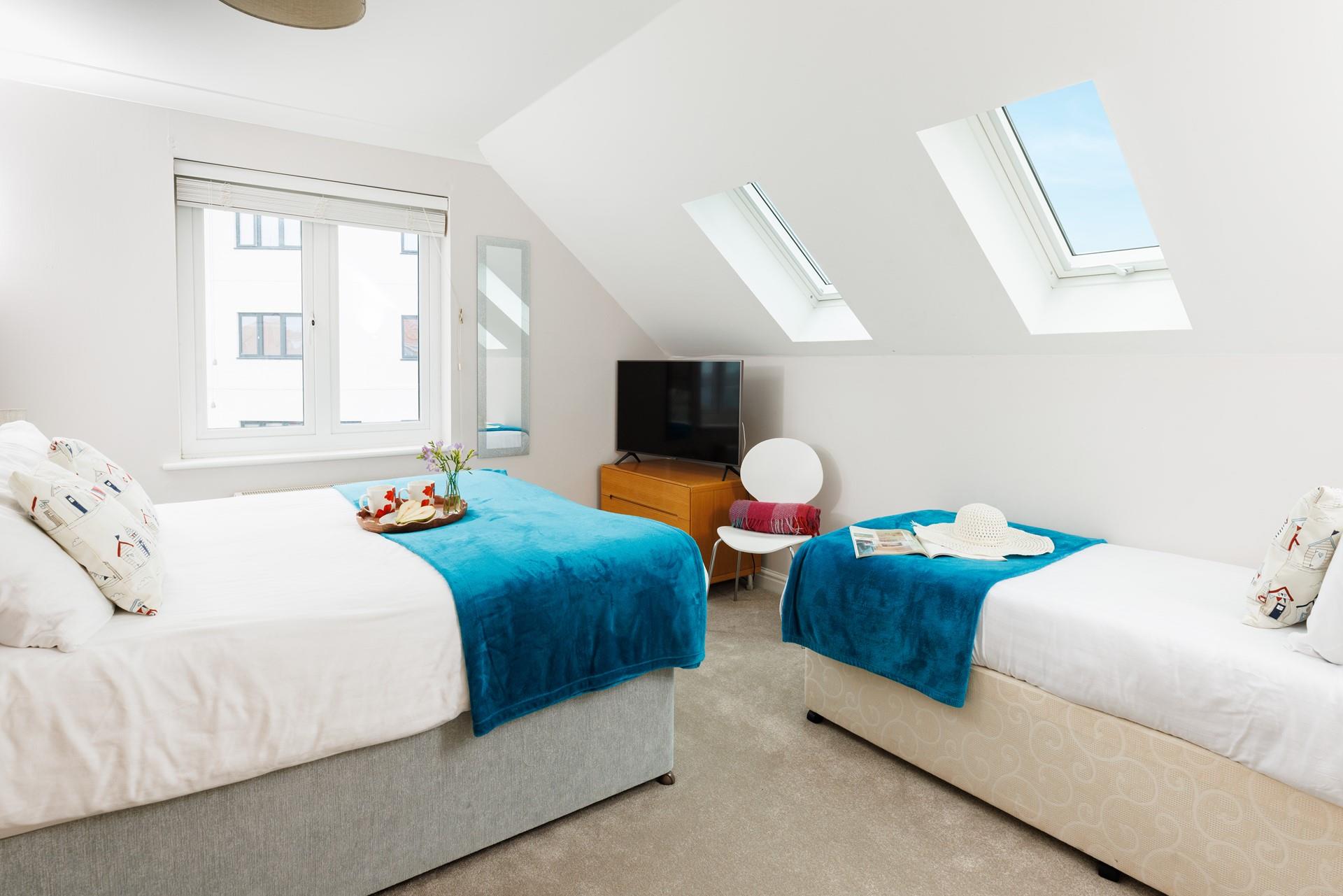 Bedroom 2 offers room for three, with zip and link beds that can be made as either king size or twin and an additional single bed. 