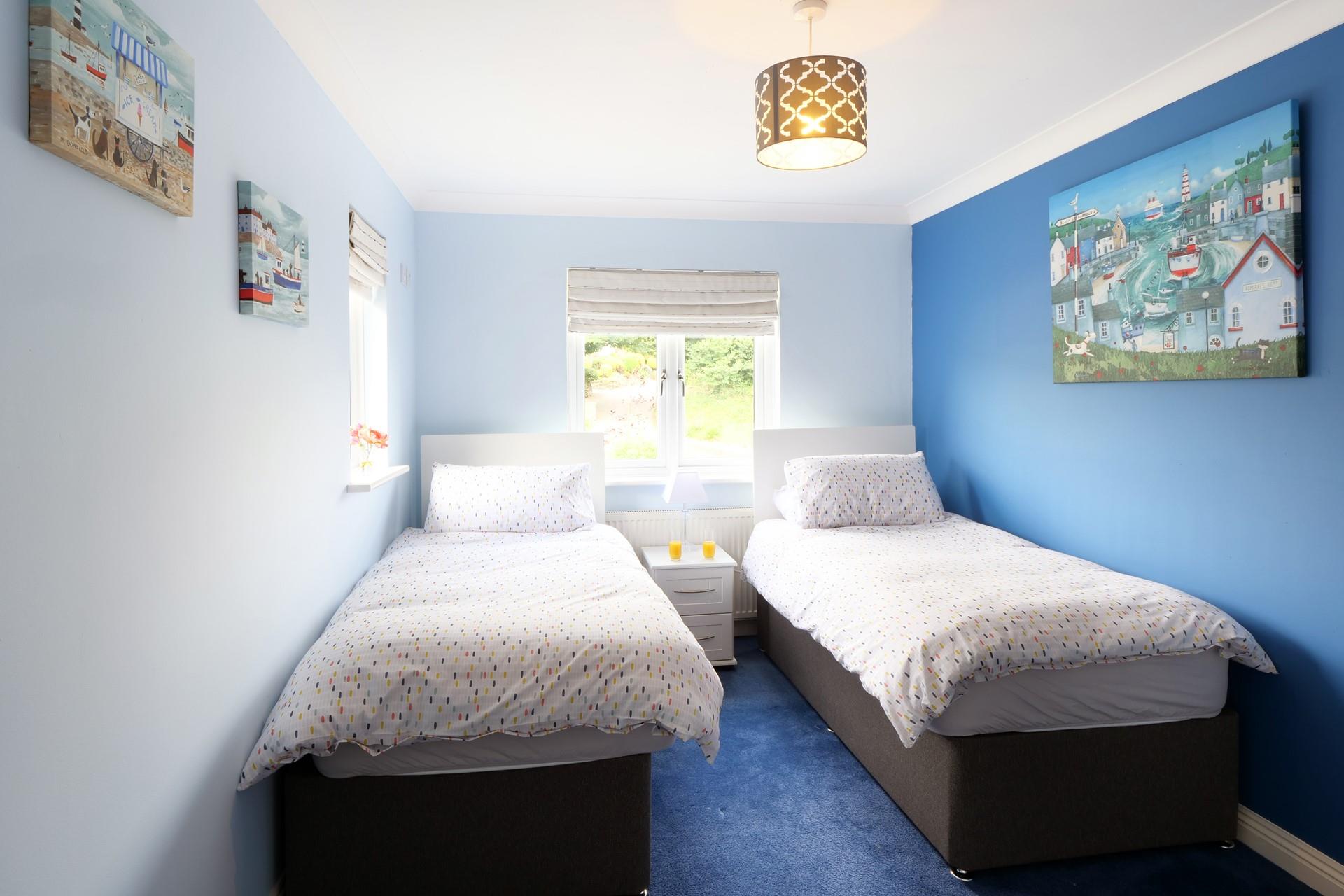 We love the coastal artwork in the twin bedroom. 