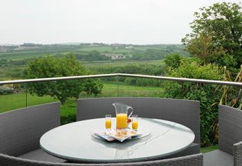 Take a moment to relax on the balcony, admiring the views across the meadows. 