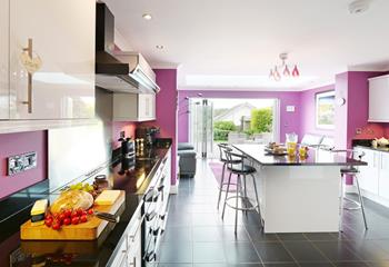 Bright, colourful, and inviting, the spacious kitchen offers plenty of space for the whole family. 