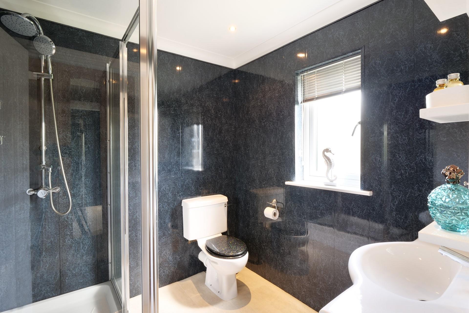 Modern and spacious, the ensuite features a large walk-in shower with rainfall showerhead. 