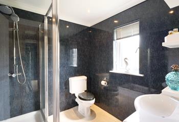 Modern and spacious, the ensuite features a large walk-in shower with rainfall showerhead. 