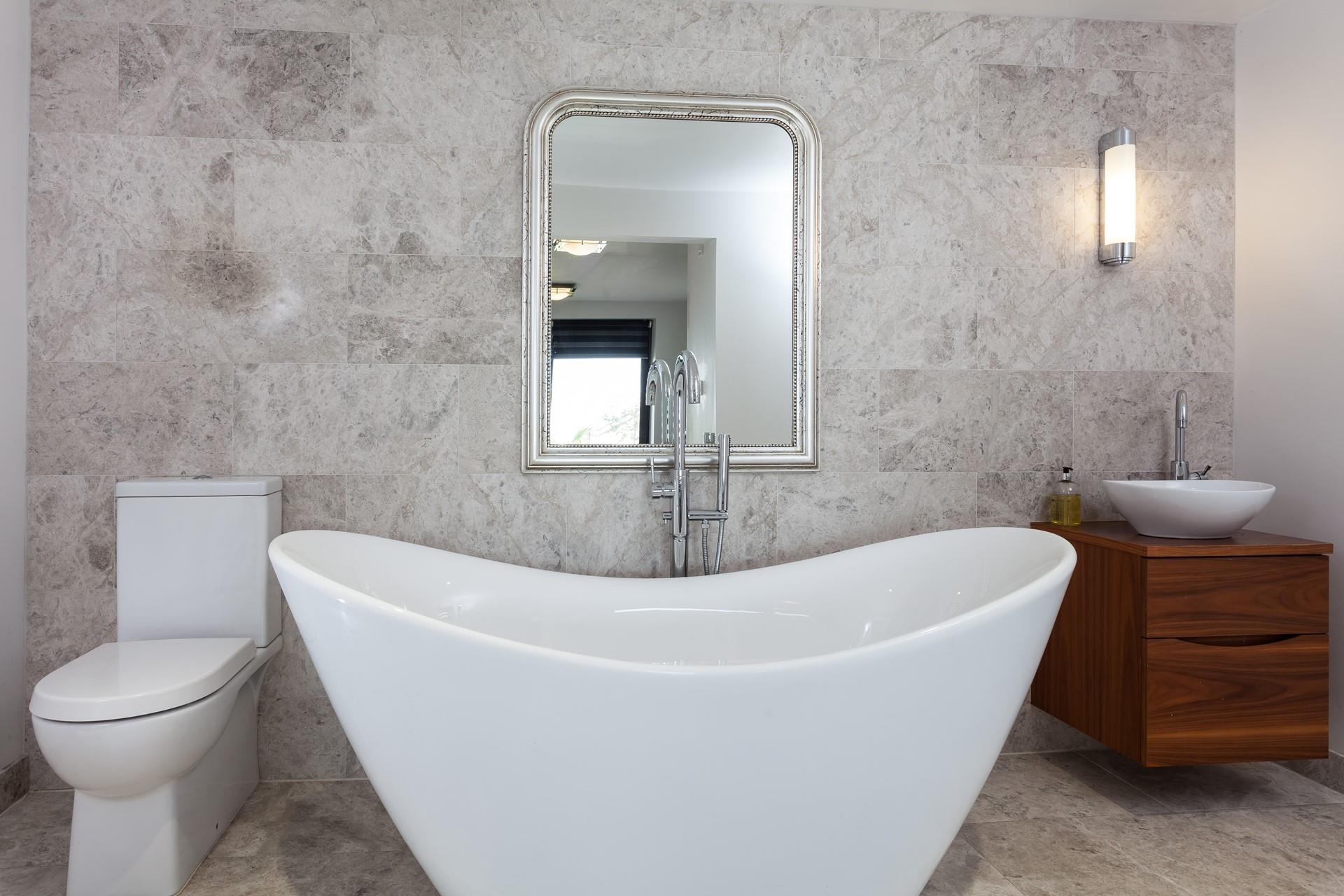 Unwind in the luxurious free-standing bath tub with a glass of wine on the side.