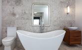 Unwind in the luxurious free-standing bath tub with a glass of wine on the side. - Thumbnail Image