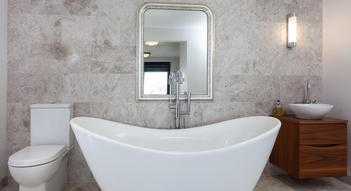 Unwind in the luxurious free-standing bath tub with a glass of wine on the side.