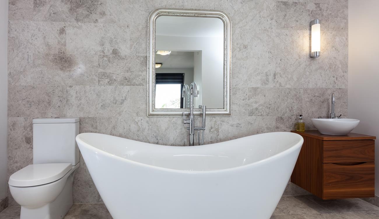 Unwind in the luxurious free-standing bath tub with a glass of wine on the side.