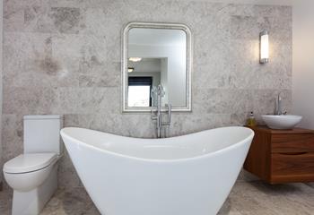 Unwind in the luxurious free-standing bath tub with a glass of wine on the side.
