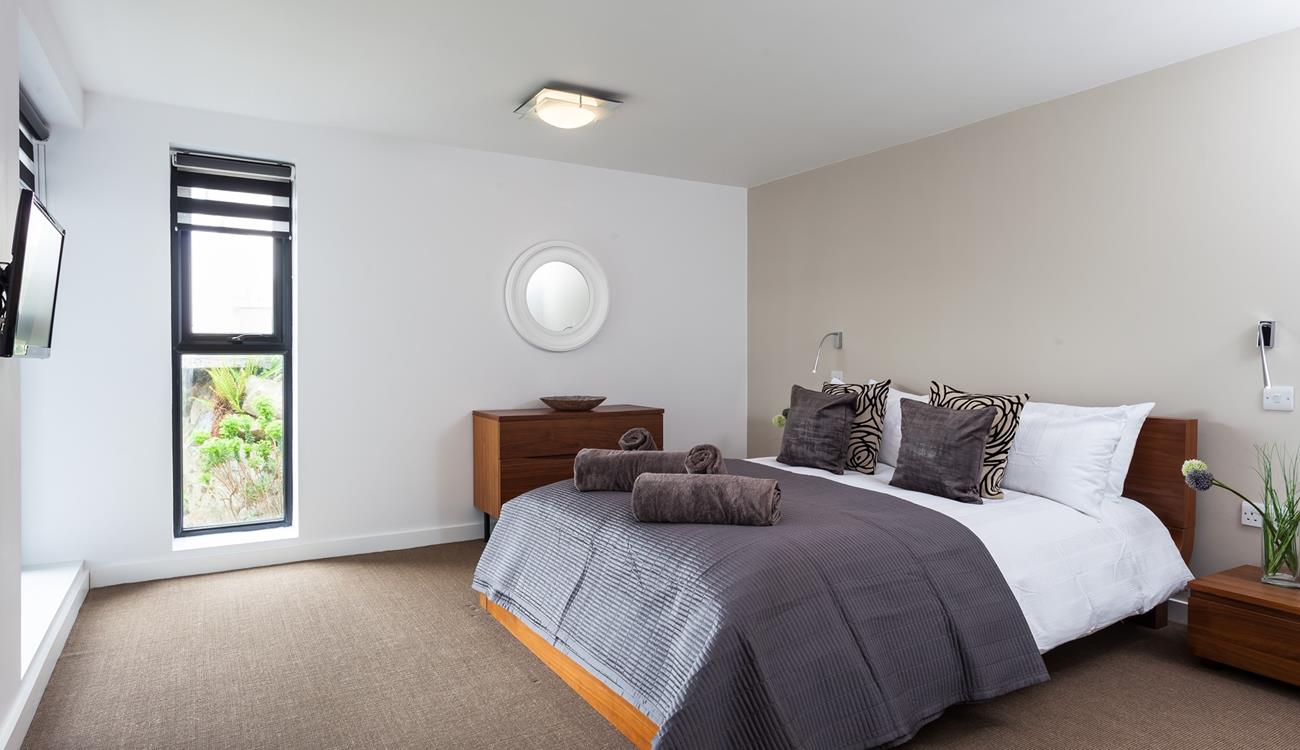 Sip your morning coffee from the spacious bed while deciding on the day's plans.