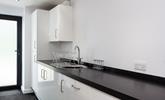 The utility area is sleek and has an ample worktop, a sink with a drainer and several cupboards for extra storage. - Thumbnail Image