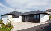 The approach and driveway at Higher Carthew is very open plan, with a dark stained timber-clad entrance wall. - Thumbnail Image